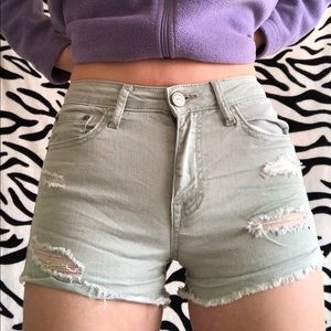 Ripped light green jean shorts